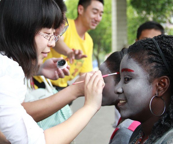 African Student getting Chinese art by a friend